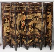 A LARGE CHINESE EIGHT PANEL LACQUER SCREEN, carved and painted with traces of gilt, depicting