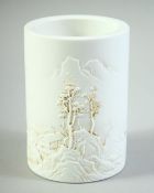 A SMALL CHINESE BLANC DE CHINE BRUSH POT, with raised decoration, the base with four character mark,