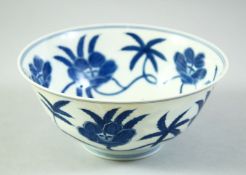 A CHINESE BLUE AND WHITE PORCELAIN BOWL, painted with large flower heads, with six character mark to