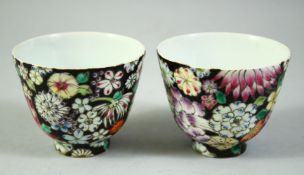 A PAIR OF CHINESE QING POLYCHROME PORCELAIN TEA CUPS, decorated with flowers, six character mark