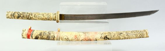 A JAPANESE SECTIONAL BONE WAKIZASHI, carved with figures, 72cm long.