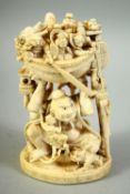 A JAPANESE CARVED IVORY OKIMONO, depicting a god holding the Takarabune / treasure ship aloft