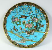 A CHINESE CLOISONNE CHARGER, decorated with birds amongst foliage. 12ins diameter.