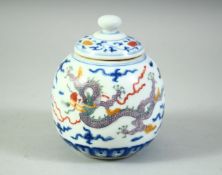 A CHINESE POLYCHROME TEA JAR AND COVER, decorated with dragons and clouds, 11.5cm high.