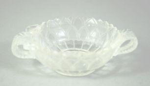 A SMALL INDIAN CUT GLASS PETAL FORM BOWL, with leaf formed twin handles, 11cm wide from handle to