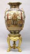 A HIGHLY IMPRESSIVE AND MONUMENTAL JAPANESE SATSUMA FLOOR STANDING VASE on a carved gilt wood stand,