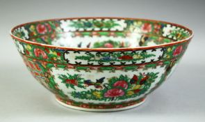 A CHINESE CANTON FAMILLE ROSE PORCELAIN BOWL, painted with panels of figures, birds and native
