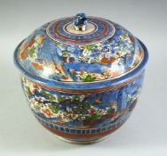 A LARGE JAPANESE ARITA PORCELAIN CLOBBERED BOWL AND COVER, painted with a landscape scene with