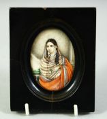AN INDIAN MINIATURE OVAL PORTRAIT OF A FEMALE FIGURE on ivory, in an ebonised wood frame and glazed,