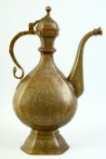 AN ISLAMIC ENGRAVED BRASS EWER, with hinged lid, engraved with floral decoration, 39cm high.