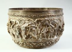A LARGE BURMESE EMBOSSED AND CHASED SILVER BOWL, with raised decoration of figural scenes and