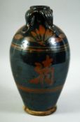 A CHINESE BLACK GLAZED POTTERY VASE, with four petal form handles to the neck, 26.5cm high.