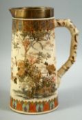 A JAPANESE SATSUMA PORCELAIN JUG, with silver band to the rim, vividly decorated with native flora