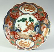 A JAPANESE IMARI PORCELAIN PETAL SHAPE DISH, painted with a bird and native flora with gilt