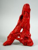 A GOOD 19TH/20TH CENTURY CHINESE PIECE OF CARVED RED CORAL, in the form of Guanyin supported by a