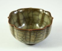 A CHINESE CRACKLE GLAZE PETAL FORM TEA CUP, 8cm diameter.
