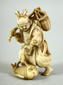 A SMALL JAPANESE CARVED IVORY FIGURE of a fisherman, with a large fish at his feet, the base inset