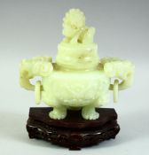 A CHINESE CARVED JADE LIDDED KORO ON A HARDWOOD STAND, with twin ring handles carved as temple