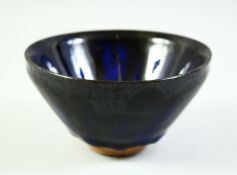 A CHINESE DARK BLUE GLAZE POTTERY BOWL, with carved mark to base, 12cm diameter.