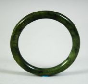 A 19TH CENTURY CHINESE JADE BANGLE, 8cm diameter.
