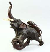 A LARGE JAPANESE MEIJI PERIOD BRONZE GROUP OF A BULL ELEPHANT being attached by two tigers, with
