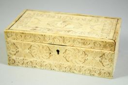 A FINE 18TH CENTURY INDIAN OR SRI LANKAN IVORY BOX, the hinged lid carved with a figure and