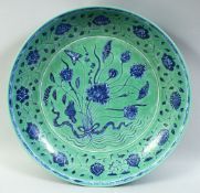 A LARGE CHINESE TURQUOISE GROUND PORCELAIN DISH, the centre painted with a floral spray surrounded