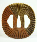 A JAPANESE MIXED METAL TSUBA, with ribbed and fluted design, 8.5cm x 7.5cm.