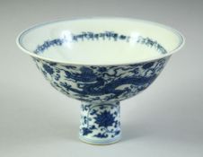 A CHINESE BLUE AND WHITE PORCELAIN STEM CUP, decorated with dragons amongst scrolling vine and