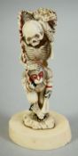 AN UNUSUAL JAPANESE CARVED IVORY OKIMONO, depicting a skeleton and monkey with a toad and another