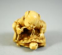 A JAPANESE CARVED IVORY NETSUKE, of a boy upon a turtle, 3.5cm wide.