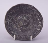 A RARE EARLY ISLAMIC OR POSSIBLY ROMAN BRONZE BOWL, the centre depicting a bird of prey surrounded