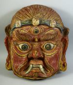 A LARGE TIBETAN CEREMONIAL PAPIER MACHE MASK, 43cm x 38cm.