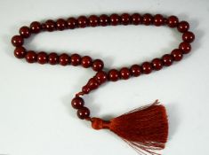 AN ISLAMIC SET OF CHERRY AMBER PRAYER BEADS, each beads approx.12mm.