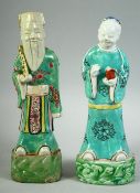 A PAIR OF 18TH CENTURY CHINESE PORCELAIN IMMORTAL FIGURES, 23cm and 22.5cm high.