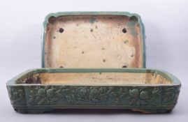 TWO LARGE CHINESE GREEN GLAZED RECTANGULAR PLANTERS, with raised floral decoration, 51cm x 38cm
