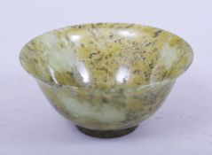 A SMALL CHINESE SPECKLED JADE BOWL, 10cm diameter.