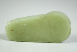 A CHINESE CELADON JADE PENDANT, decorated with auspicious characters, 2.7in high.