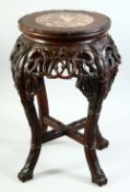 A CHINESE HARDWOOD AND MARBLE INSET STAND, with carved and pierced frieze, supported on four curving