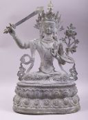 A LARGE BRONZE FIGURE OF A DEITY HOLDING A SWORD, 38cm high.