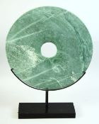 A LARGE CHINESE MARBLE BI DISK, raised on a fitted stand, the stand 40cm diameter, 53cm high on
