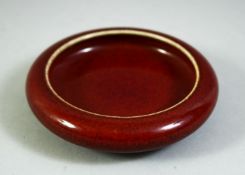 A CHINESE RED GLAZED BRUSH WASH, 10cm diameter.