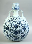 A CHINESE BLUE AND WHITE PORCELAIN TWIN HANDLE MOONFLASK, painted with foliate decoration, 33cm