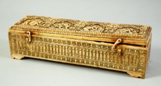 A FINE AND RARE 17TH/18TH CENTURY SOUTH INDIAN CARVED IVORY PEN BOX, the hinged lid carved with