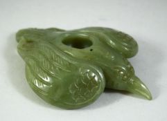 A CARVED JADE MODEL OF A BIRD, 11cm long.