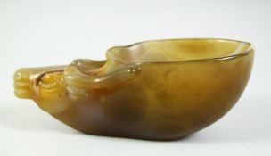 A CHINESE BUFFALO HEAD AGATE CUP, the predominantly celadon green stone with russet and white