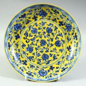 A CHINESE YELLOW GROUND BLUE AND WHITE PORCELAIN DISH, decorated with lotus and vine, six