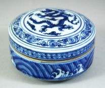 A CHINESE BLUE AND WHITE PORCELAIN CIRCULAR BOX AND COVER, the cover with a central dragon, the