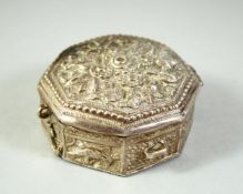 AN ISLAMIC WHITE METAL OCTAGONAL QURAN AMULET BOX, possibly silver, 5.5cm diameter.