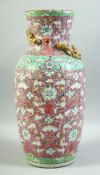 A LARGE CHINESE PINK GROUND FAMILLE ROSE PORCELAIN VASE, decorated with flower and bat motifs and